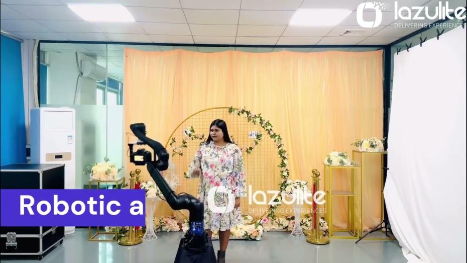 A robotic camera arm filming a guest at a branded photo activation.