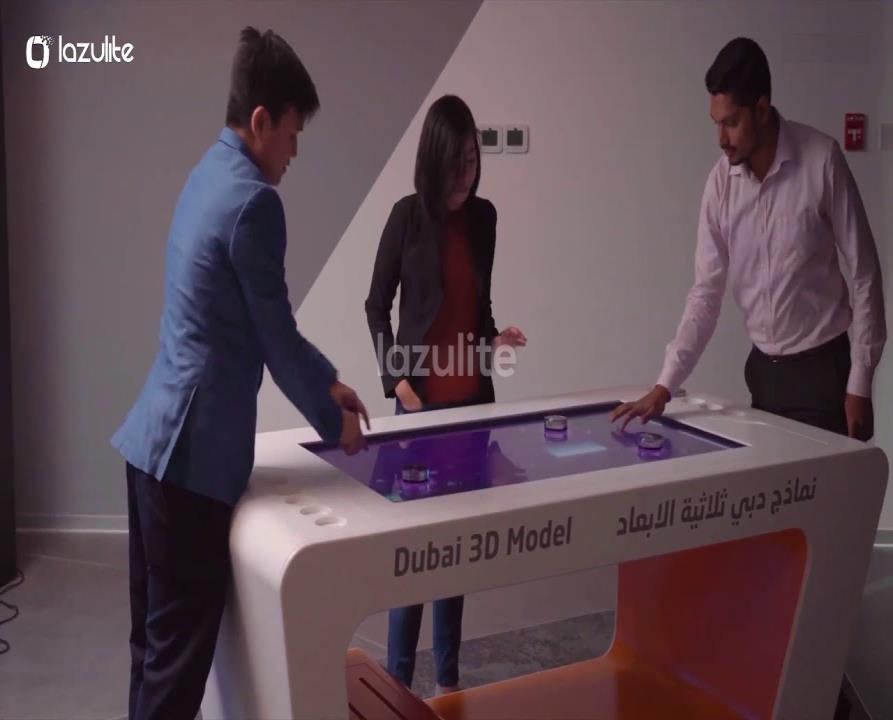 Visitors exploring a multi-touch interactive table.