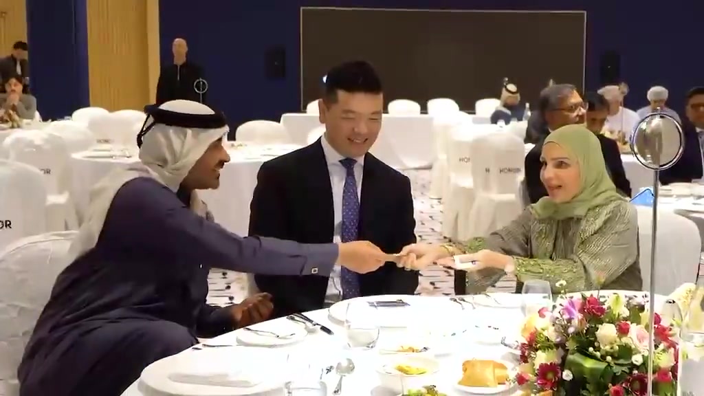 Guests seated at a dressed banquet table during a HONOR gathering.