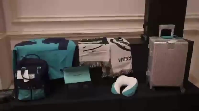 Travel accessories and gift items displayed at a corporate evening.