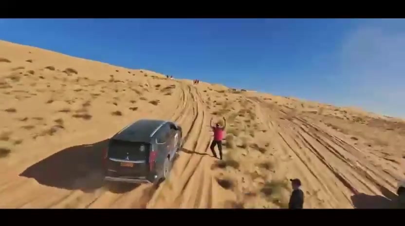 Mitsubishi Montero vehicles and guests in the desert.