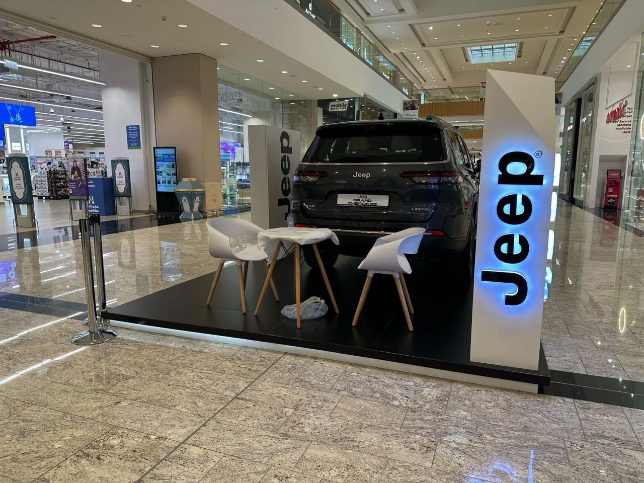 A Jeep mall display with branded lighting and guest seating.