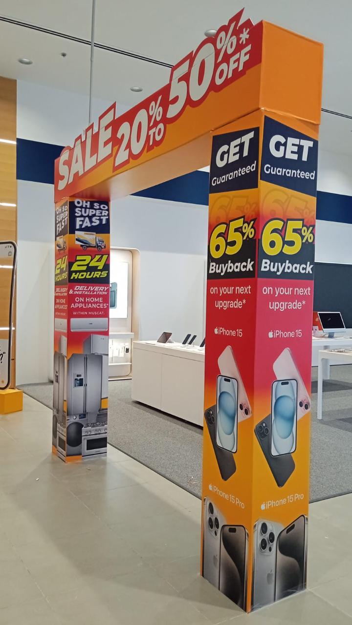 A printed retail entrance structure with promotional graphics.